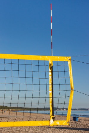 Volleyball yellow net on sand at beach. Sport, recreation and healthy lifestyles on fresh air. Vacation timeの写真素材