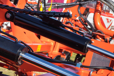 Black pistons or actuators in red pneumatic or hydraulic machine. Technology and engineeringの写真素材