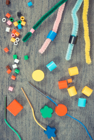 Thread, creative sticks and colorful beads used to making bracelets, learn counting and arranging various shapes. Development of children motor skills, creativity and logical thinkingの写真素材