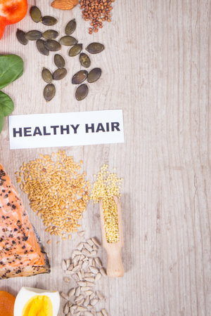 Fresh healthy eating as source various natural vitamins or minerals. Hair in good condition concept. Place for text or inscription on boardの写真素材