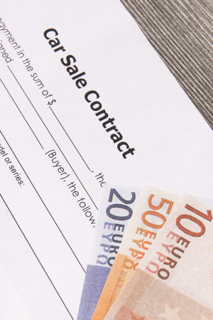 Form of car sale agreement and euro banknotes. Sales and purchases new or used vehicles