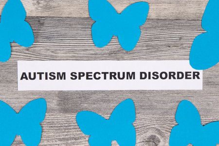 Blue shapes of butterflies and inscription Autism Spectrum Disorder. World Autism Awareness Day conceptの写真素材