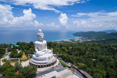 Big white buddha statue on top of the mountain with blue sky in Phuketの写真素材