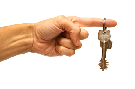 hand and keys on a white backgroundの写真素材