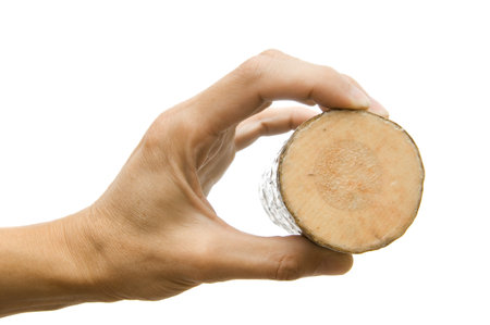 Wooden block in a hand on a white backgroundの写真素材