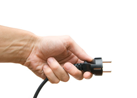 Electric plug in a hand on a white background