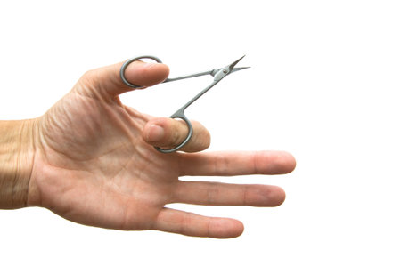 Scissors in a hand on a white background