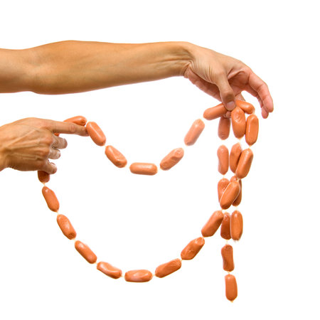 Sausages in hands on a white backgroundの写真素材