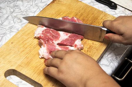 Meat cutting on a chopping boardの写真素材