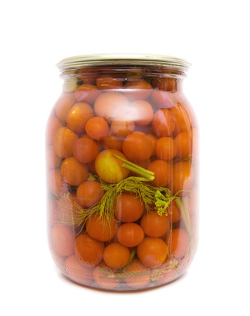 Tinned tomatoes in a glass jar on a white backgroundの写真素材