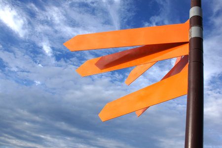 Directional signal against the blue sky with cloudsの写真素材