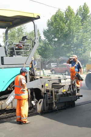 MOSCOW - JUNE 22: The brigade of visitors workers repairs road under the program of planned repair...