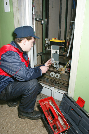 The master repairs the lift equipment in an apartment houseのeditorial素材