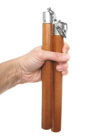 Nunchaku in a hand to isolate on the whiteの写真素材