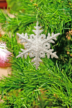 Artificial snowflake on a green fur treeのeditorial素材