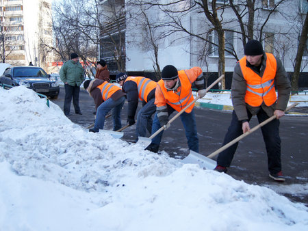 20.01.2012 Moscow. Guest workers clean snow shovels from street.のeditorial素材