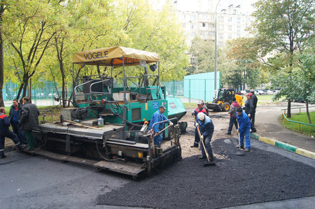 Packing of a new asphalt covering on road before an apartment house within the limits of the city program of an accomplishment of domestic territories, on september 30, 2011, in Moscow.のeditorial素材