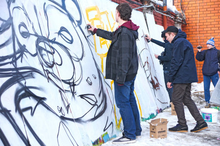 MOSCOW - MARCH 17:  Participants of competition draw on a wall of graffiti at the first stage of city festival Graffiti jam. on MARCH 17, 2012 in Moscow, Design factory Bottle.のeditorial素材