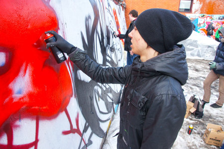 MOSCOW - MARCH 17:  Participants of competition draw on a wall of graffiti at the first stage of city festival Graffiti jam. on MARCH 17, 2012 in Moscow, Design factory Bottle.のeditorial素材