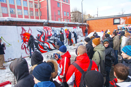 MOSCOW - MARCH 17:  Spectators look at participants of competition of graffiti at the first stage of city festival Graffiti jam. on MARCH 17, 2012 in Moscow, Design factory Bottle.のeditorial素材