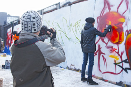 MOSCOW - MARCH 17:  Participants of competition draw on a wall of graffiti at the first stage of city festival Graffiti jam. on MARCH 17, 2012 in Moscow, Design factory Bottle.のeditorial素材