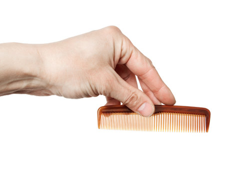 hairbrush in a hand, it is isolated on the whiteの写真素材