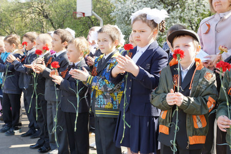 MOSCOW - MAY 5: School students congratulating the veterans of World War II at the celebration of Victory Day on May 5, 2012 in Moscow, Russia のeditorial素材