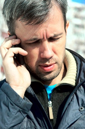 the man talks by the mobile phoneの写真素材