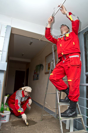 February 15, 2013, Moscow. Workers make repairs to the porch of a house.のeditorial素材