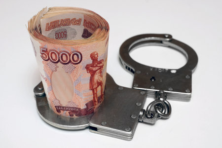 Banknotes and metal handcuffsの写真素材