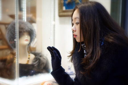 Beautiful Asian girl looking at shop windowの写真素材