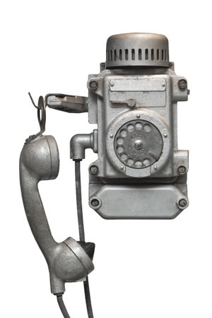Vintage metal disk phone for heavy operating conditions.Isolated on white .の写真素材