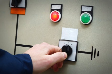 Hand a man in overalls includes an electric switch, two signal lights, red and green on the...