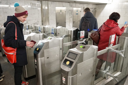 MOSCOW, RUSSIA - April 01, 2018: Passengers pass through turnstiles. The functioning of the subway...