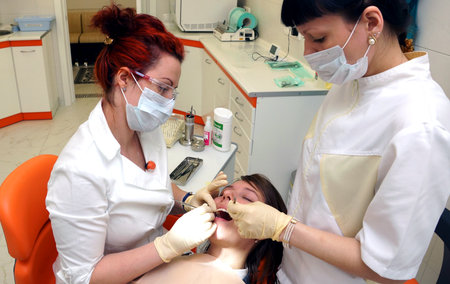 MOSCOW, RUSSIA - May 10, 2016: Doctors dentists treat the teeth to the patient. Private dental clinic in Moscow.のeditorial素材