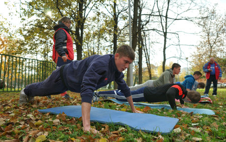 MOSCOW, RUSSIA - October 11, 2014: Sport push-up, young man pressing from the ground. Physical training in a municipal school in Moscow.のeditorial素材