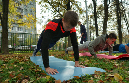 MOSCOW, RUSSIA - October 11, 2014: Sport push-up, young man pressing from the ground. Physical training in a municipal school in Moscow.のeditorial素材