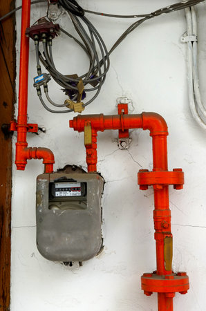 Gas meter and electric wires on the wall.の写真素材