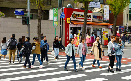 Seoul, South Korea - April 2018: The crowd at the pedestrian crossing. Young, beautiful Korean women. Cityscape.のeditorial素材