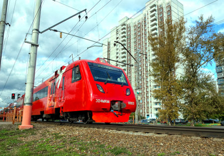 MOSCOW, RUSSIA - SEPTEMBER, 2018: The electric train quickly rushes past residential buildings.のeditorial素材