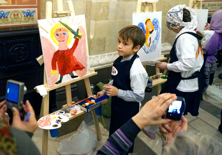 MOSCOW, RUSSIA - OCTOBER, 2018: The boy draws an angel in the Cathedral of Christ the Savior.のeditorial素材