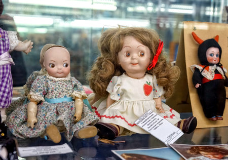 MOSCOW - MARCH, 2018: Porcelain dolls. Showcase with old toys in a retro toy store.のeditorial素材
