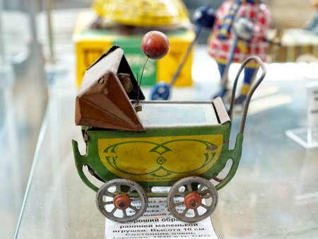 MOSCOW - MARCH, 2018: Miniature baby stroller. Showcase with old toys in a retro toy store.のeditorial素材