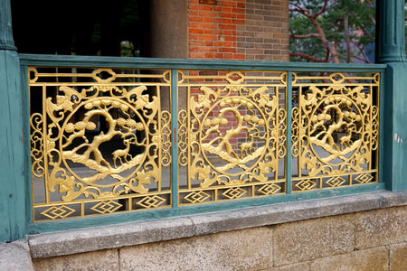 Metal ornament on the fence of an ancient Korean palace building. Deoksugung Palace, Seoul.のeditorial素材