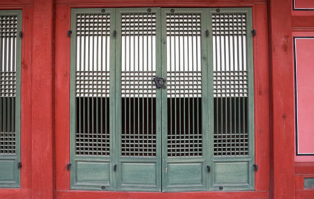 Part of the facade with a closed window of an ancient Korean palace building. Deoksugung Palace, Seoul.のeditorial素材