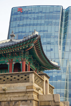Seoul, Republic of Korea - March 2019: Dongshipjagak, ancient watchtower, Seoul landmark. Modern office buildings in the background.のeditorial素材