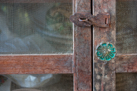 Close up of an old and rusty hinge. On a wooden frameの写真素材