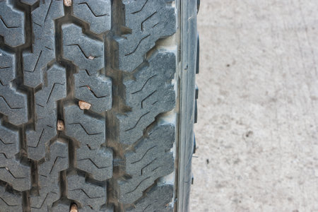 Close up of old car tires are mounted on the tablets of stone treads.の写真素材