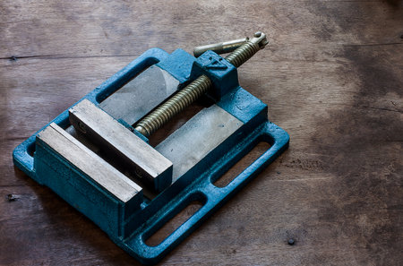 Green table vice on oldwood background.の写真素材