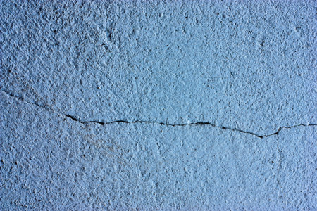 Sky blue walls are textured black dirt stains.の写真素材